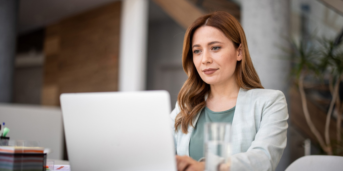Young woman using a laptop in an office building